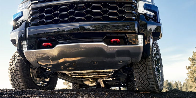 2026 Chevrolet Silverado 1500 front grille viewed from below, emphasizing its rugged design and aggressive stance, perfect for off-road adventures around Buellton, CA.
