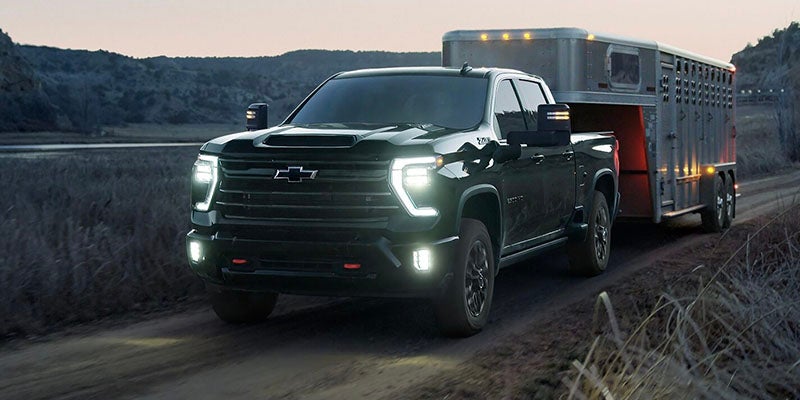 2026 Chevrolet Silverado 1500 headlights lighting the way for nighttime towing, ensuring visibility and safety on dark roads in Buellton, CA.